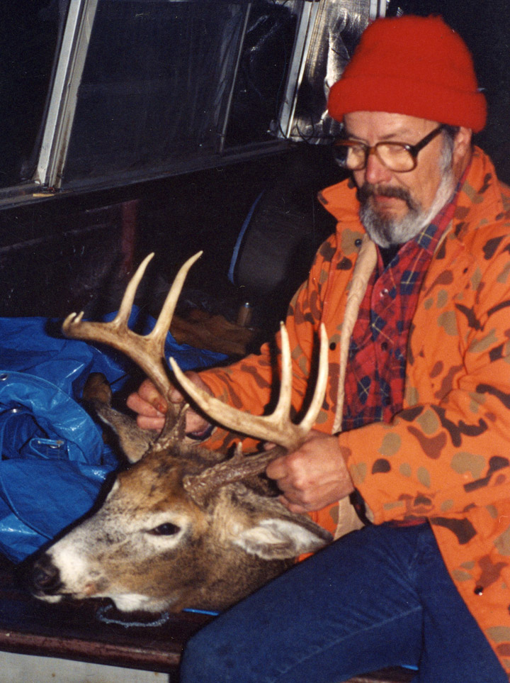 Doc with his 1990 9-point whitetail buck, back at his truck.