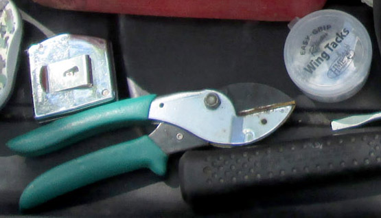 A pruner and fluorescent tacks.